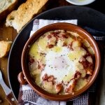 Baked eggs with potatoes and anchovies